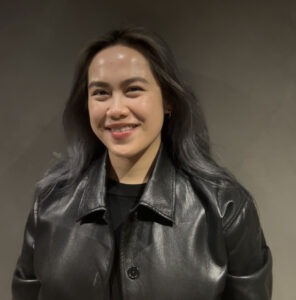 photo of a woman with long dark hair wearing a black jacket
